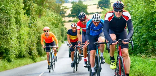 Cyclists racing on country roads on a sunny day in the UK