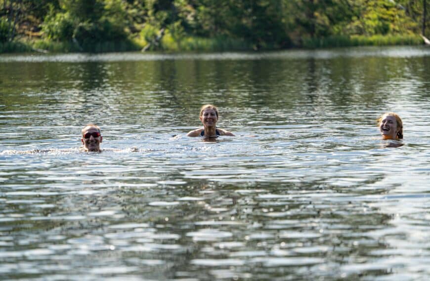 people swim in outdoor water scaled