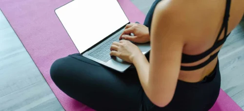 woman relaxing her body from office work by practicing yoga scaled