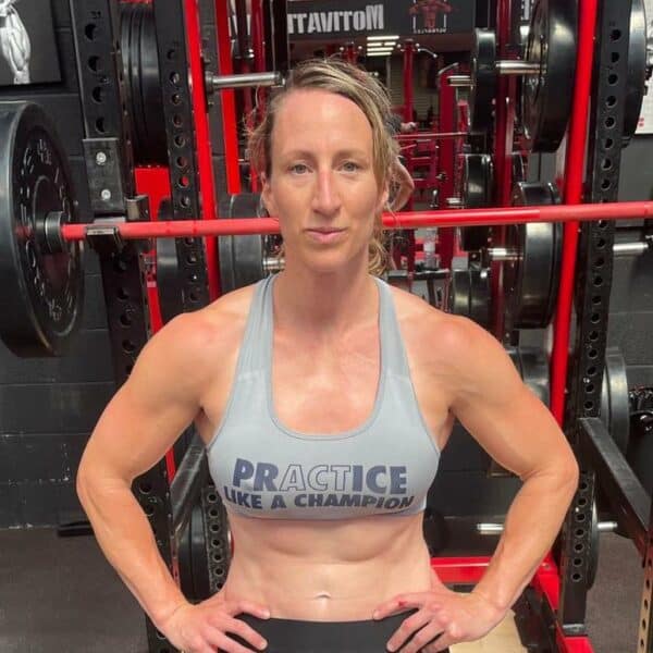 Kat Merchant stands in front of gym equipment