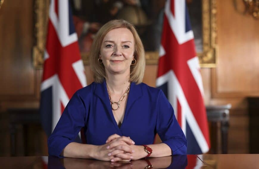 Liz Truss in front of union flags in office