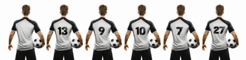 soccer player holding the ball with his back twisted with different popular shirt numbers