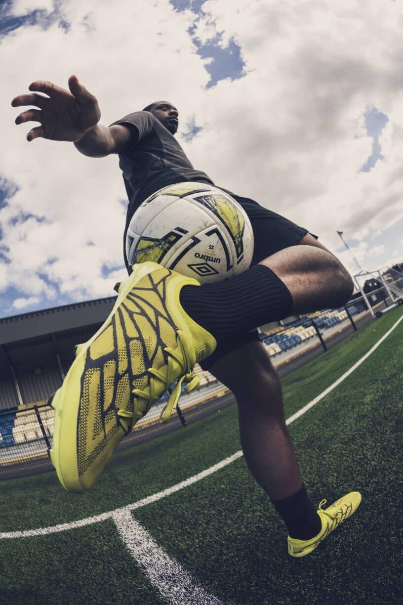 umbro footballer performing a skill move wearing Velocita Alchemist football boots