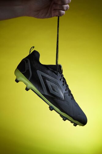 Umbro tocco 2 football boot hanging from lace