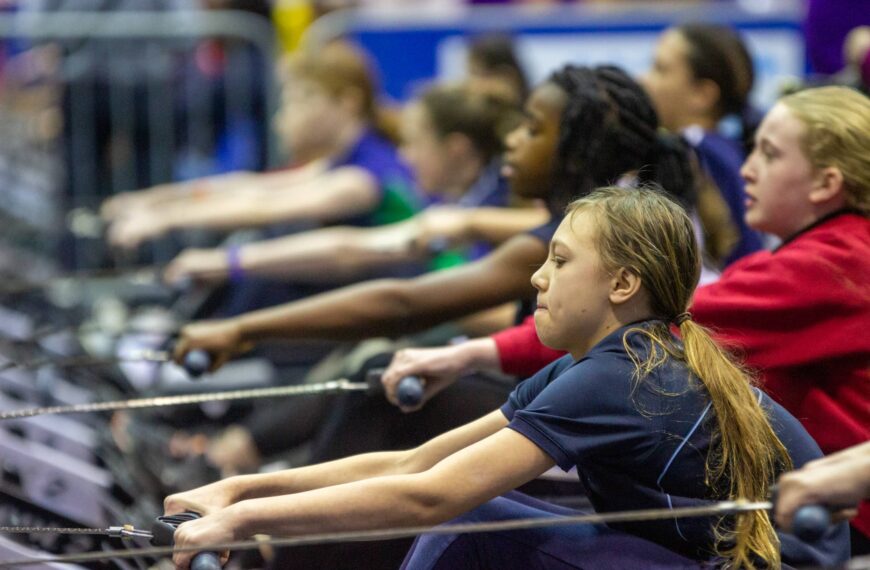 youngsters race on indoor rowing machines