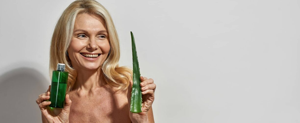 woman hold aloe vera leaf and lotion