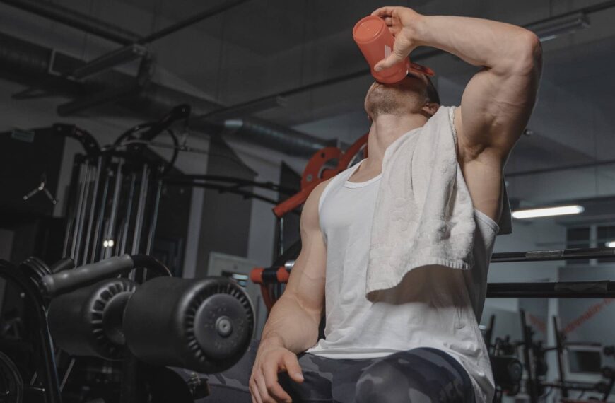 man drinks in gym