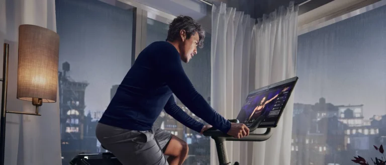 man on Peloton looks out of autumnal window of flat 1