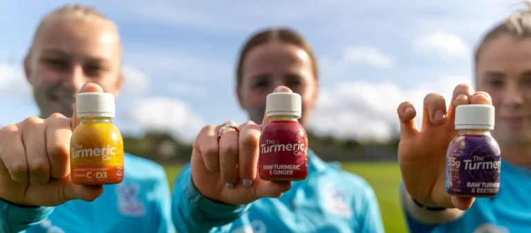palace women hold turmeric