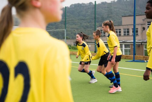 young girls playing football