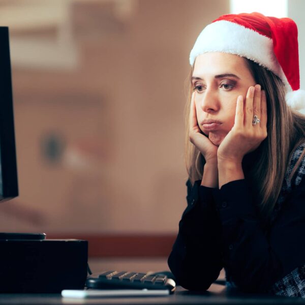 Stressed worker spending time overworking during winter holidays