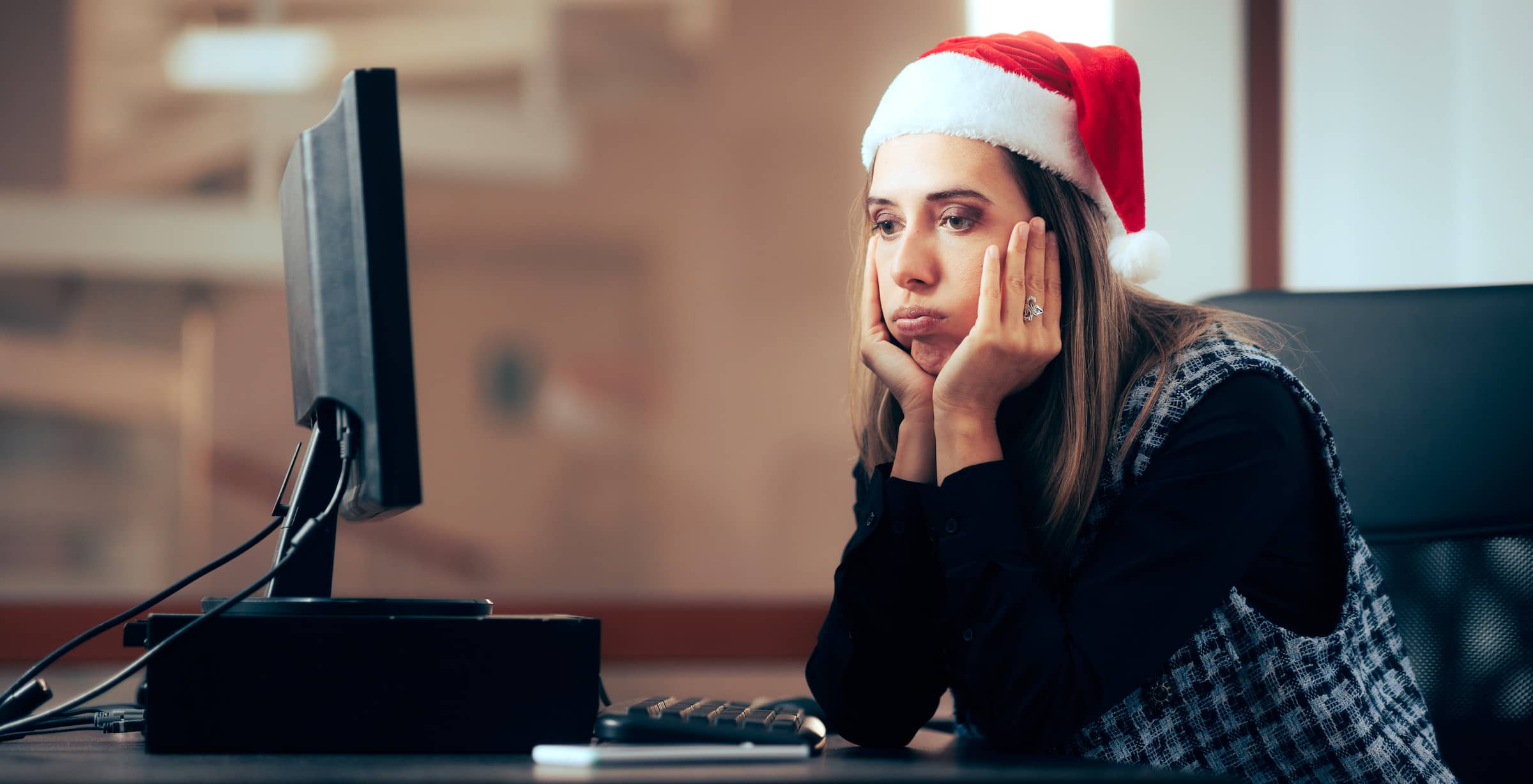 Stressed worker spending time overworking during winter holidays