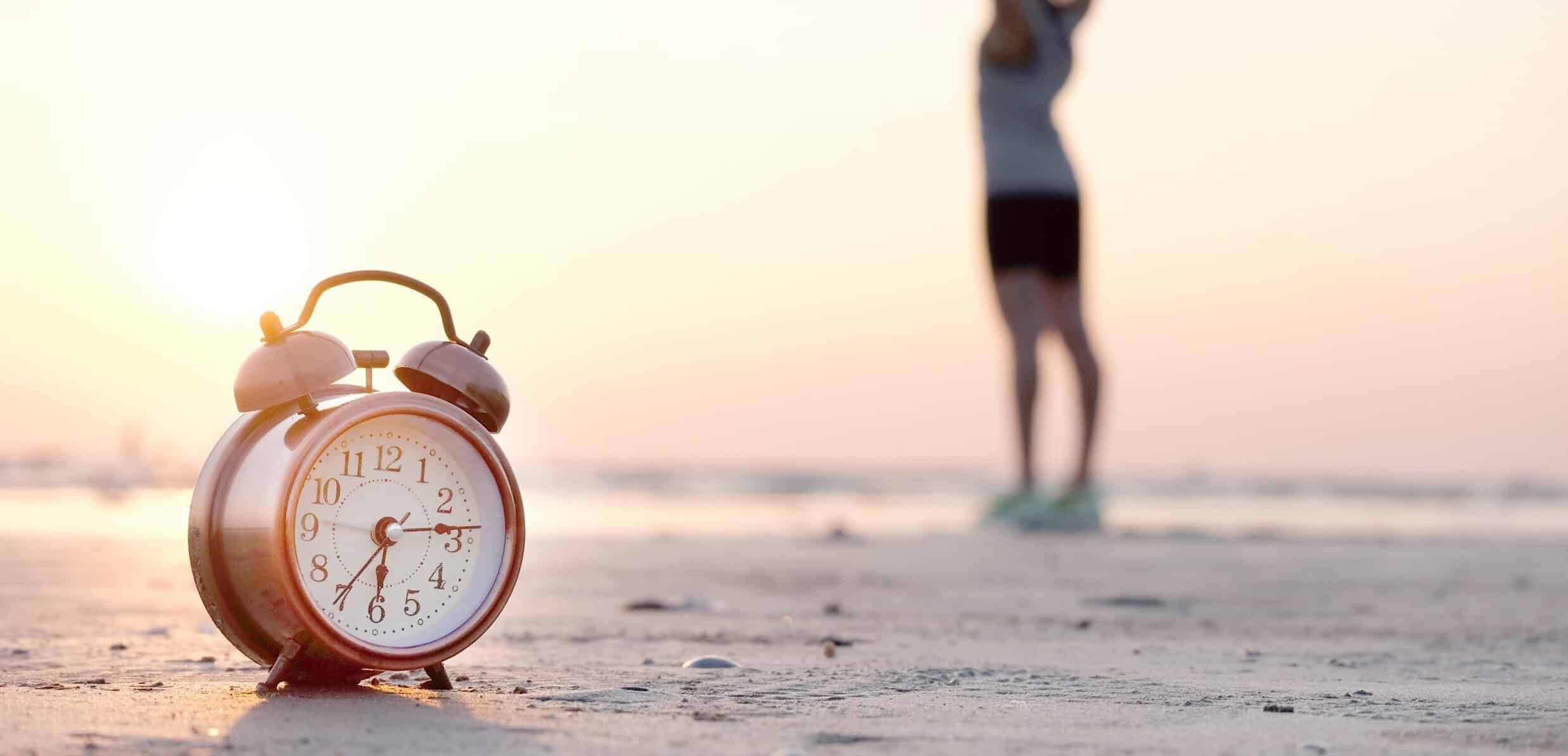 Active person on beach with alarm clock in view