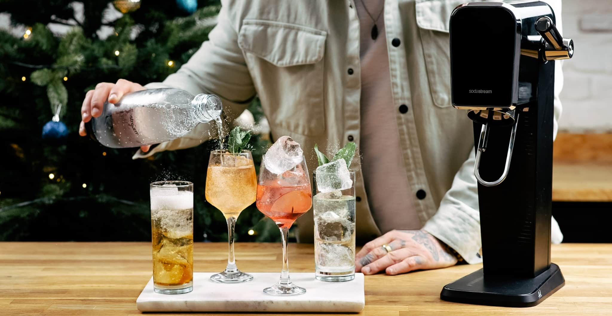 Person makes cocktails with sodastream machine