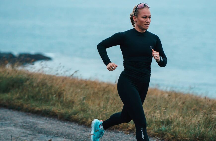 woman running along cornish coast