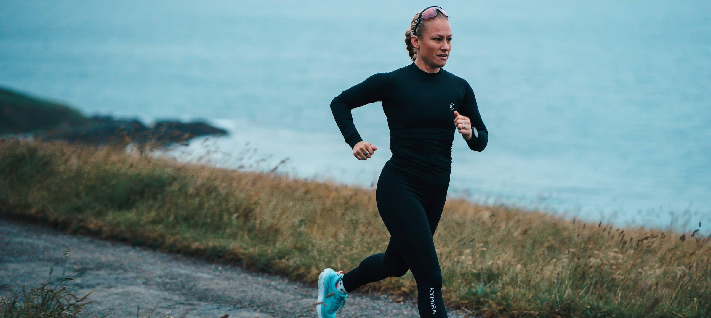 Woman running along cornish coast