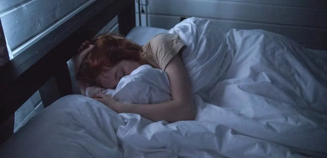 woman sleeps with light creeping through