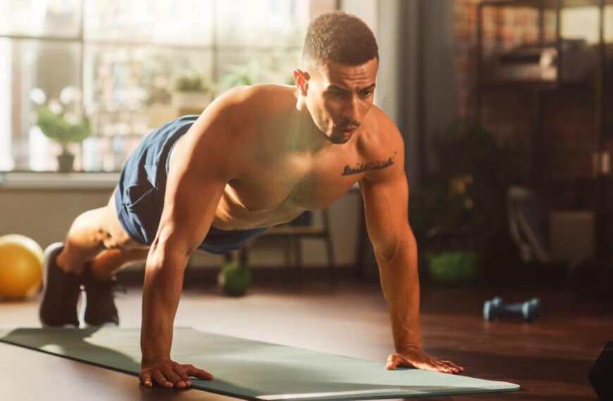 Strong Athletic Man Does Shirtless Workout at Home Gym, Doing Push Ups. Lean Fit Muscular Mixed Race Sportsman Staying Healthy, Training at Home. Sweat and Determination lead to Success