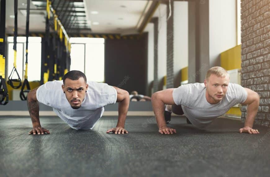 two fitness men hold push up position