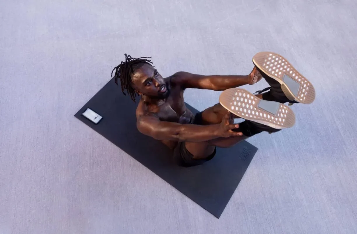 freeletics man lays on yoga mat
