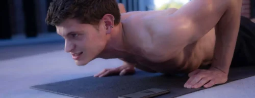 fit man on mat with freeletics app