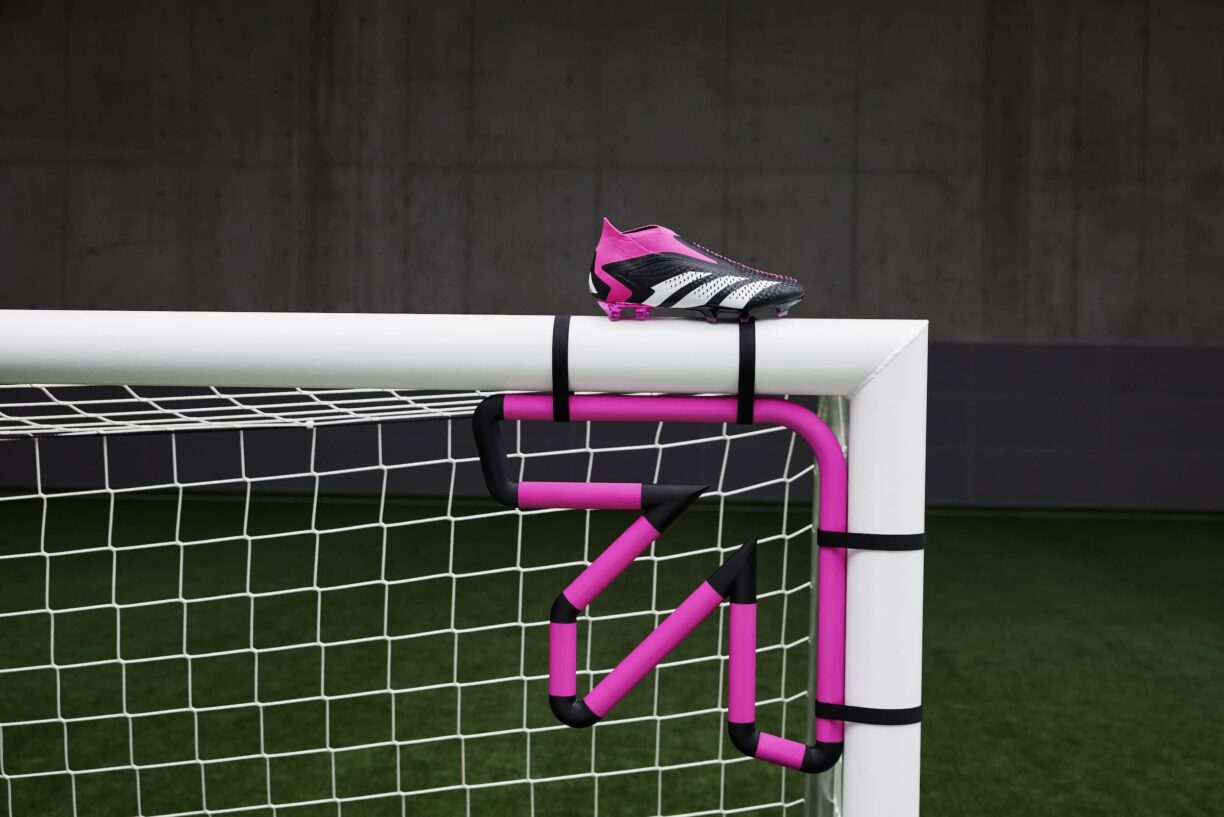 Adidas predator football boots on top of goal post