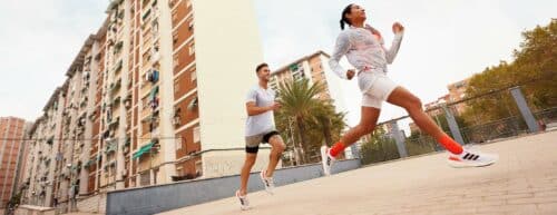 athletes run wearing adidas shoes