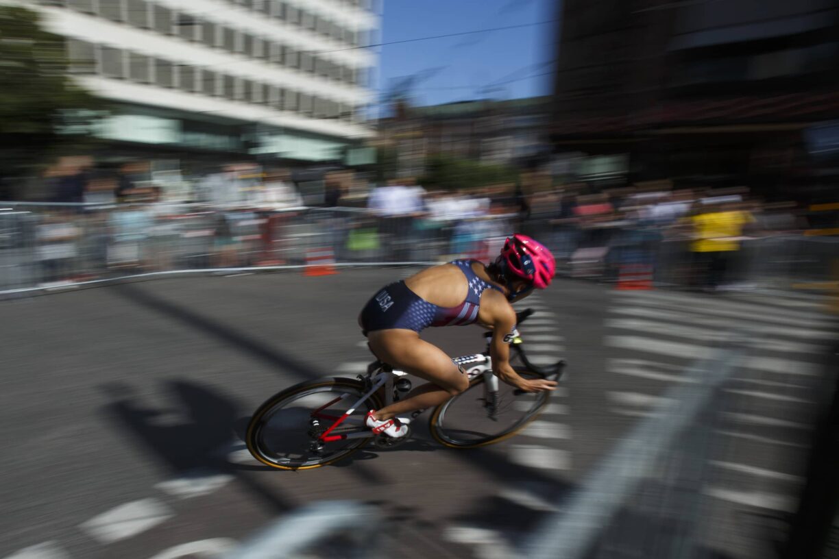 Cyclist races at speed with blurred background