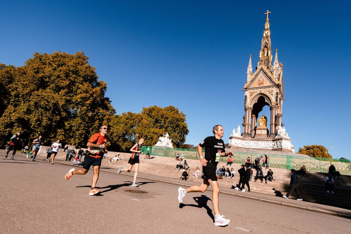 Runners run past the royal albert memorial