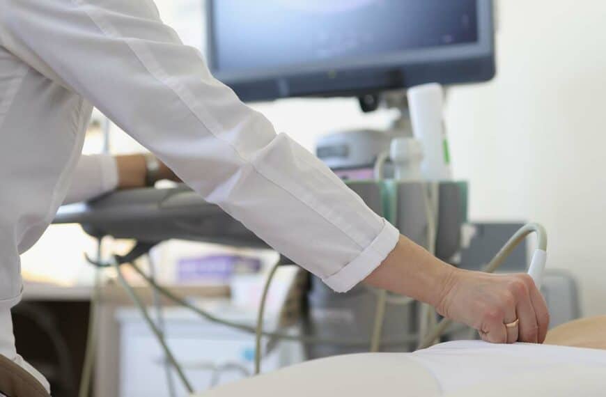 Woman doctor makes an ultrasound abdomen to the patient