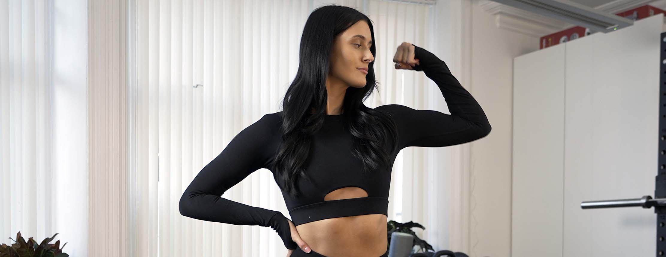 Shreddy fitness model flexes arm