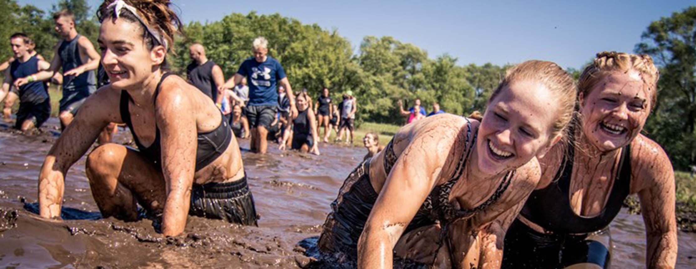 Tough mudder women fight their way through mud