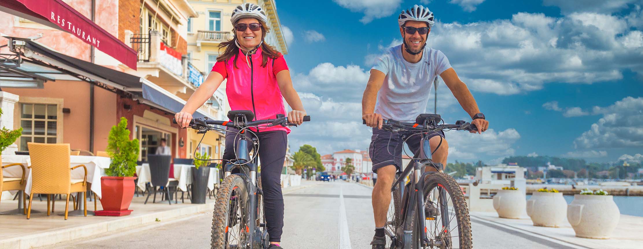 Active couple riding an E-Bike during a holiday