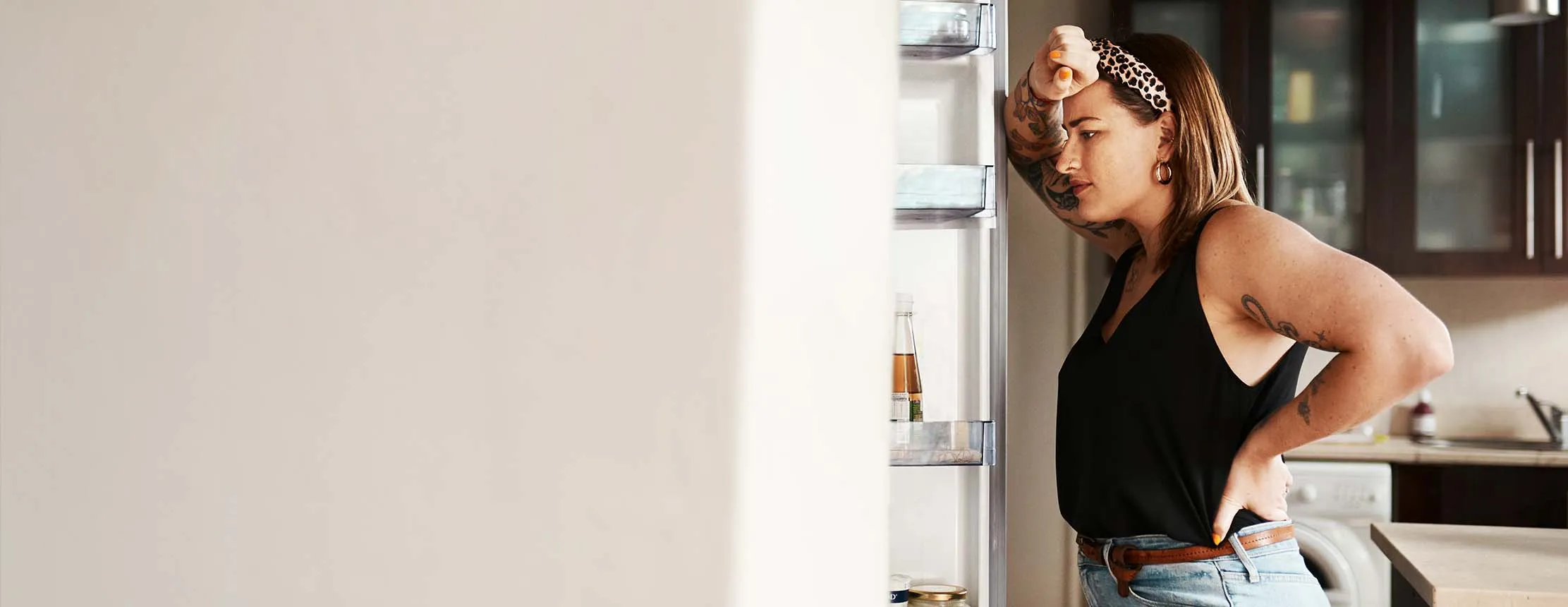 Hungry woman looking in a fridge