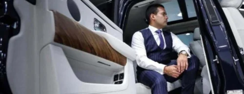 adam rasul exits his car