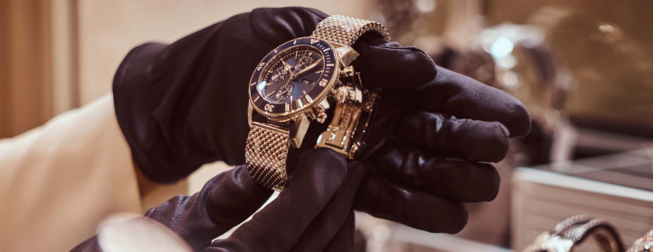 Gloved hands hold expensive luxury watch