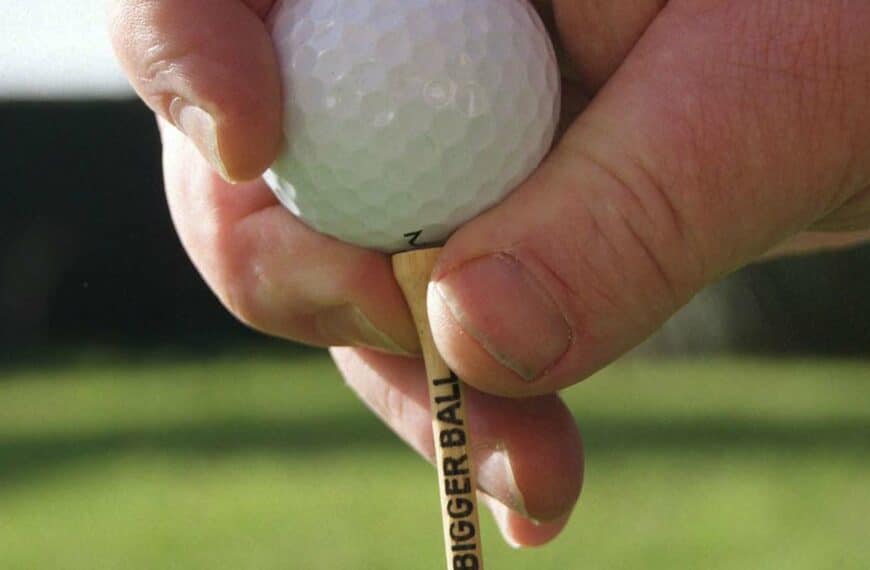 golf ball on tee being placed into ground