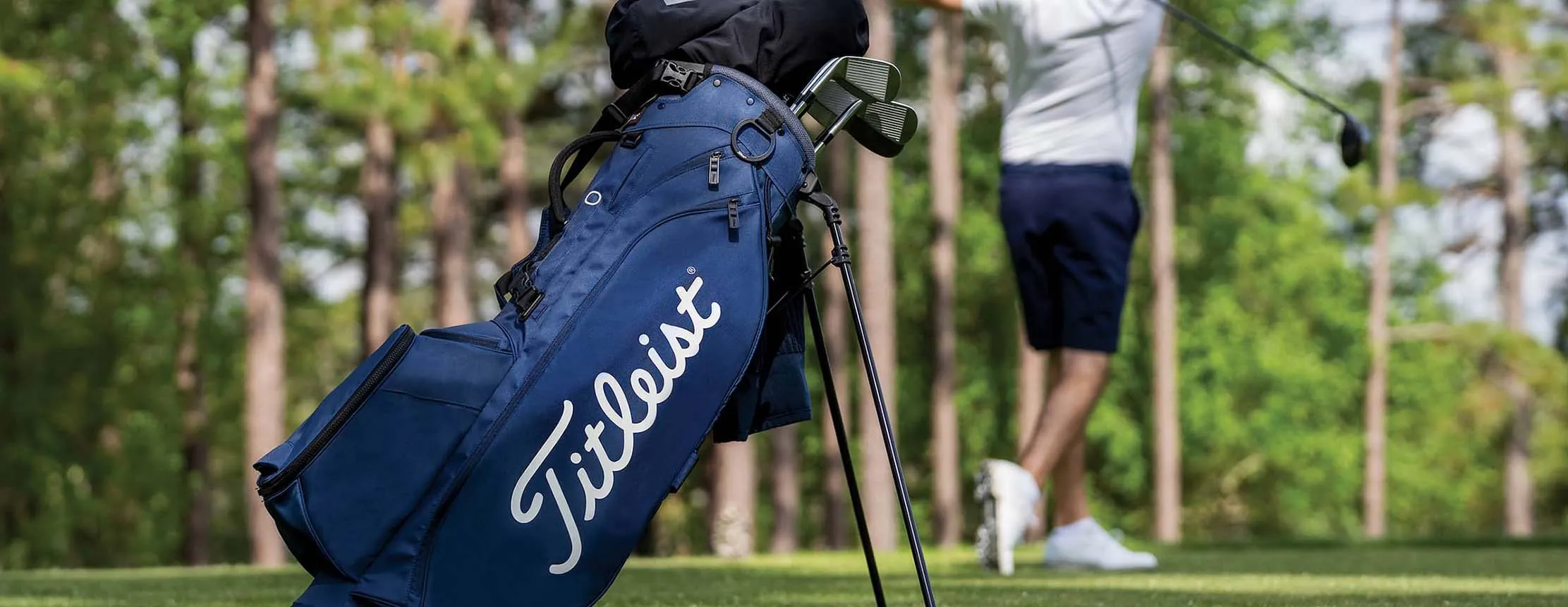 titleist golf stand bag in front of golfer
