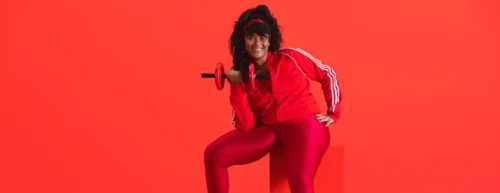 young fitness model lifting small dumbbell