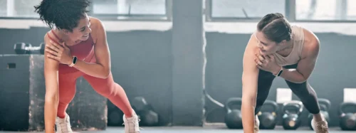 Gym floor, health and training woman doing arm plank exercise, performance workout or core muscle building