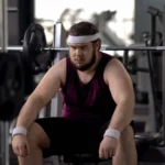 Tired man thinking over problems, desire to lose weight, gym workout