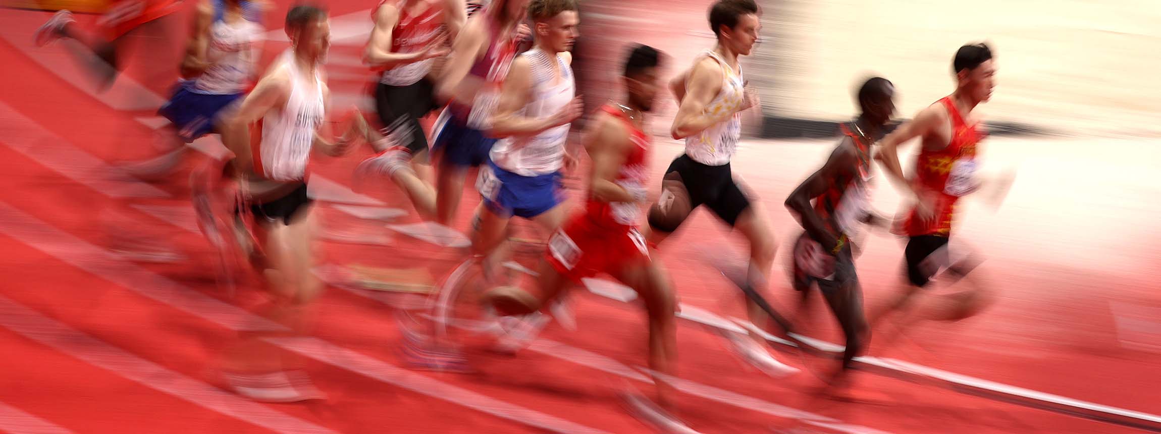 Athletes run around track