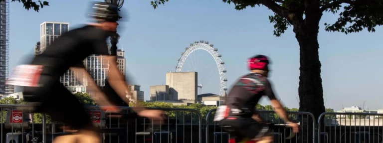 blurred cyclists in view of london eye