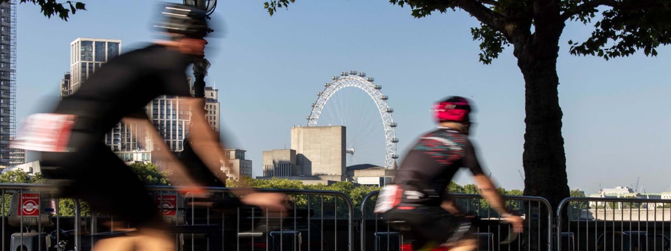 Blurred cyclists in view of london eye