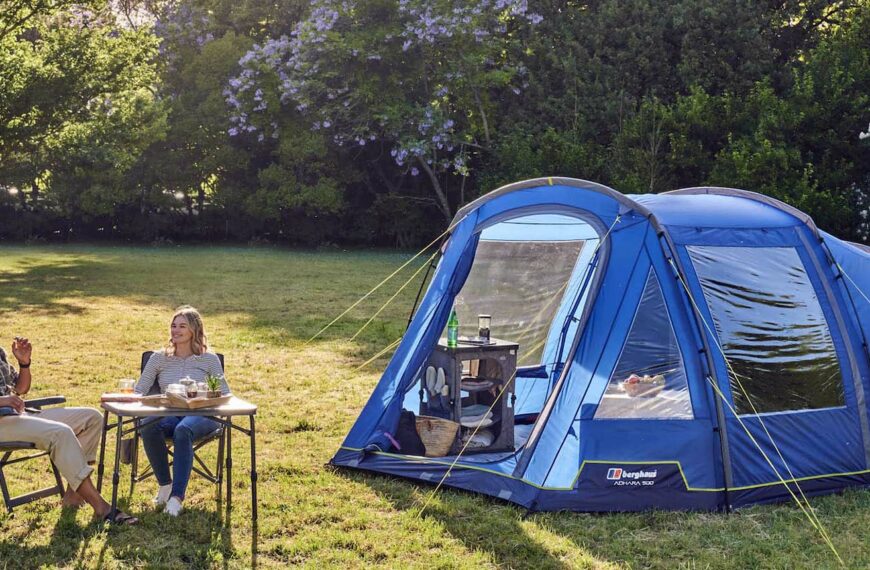 couple sit outside a tent