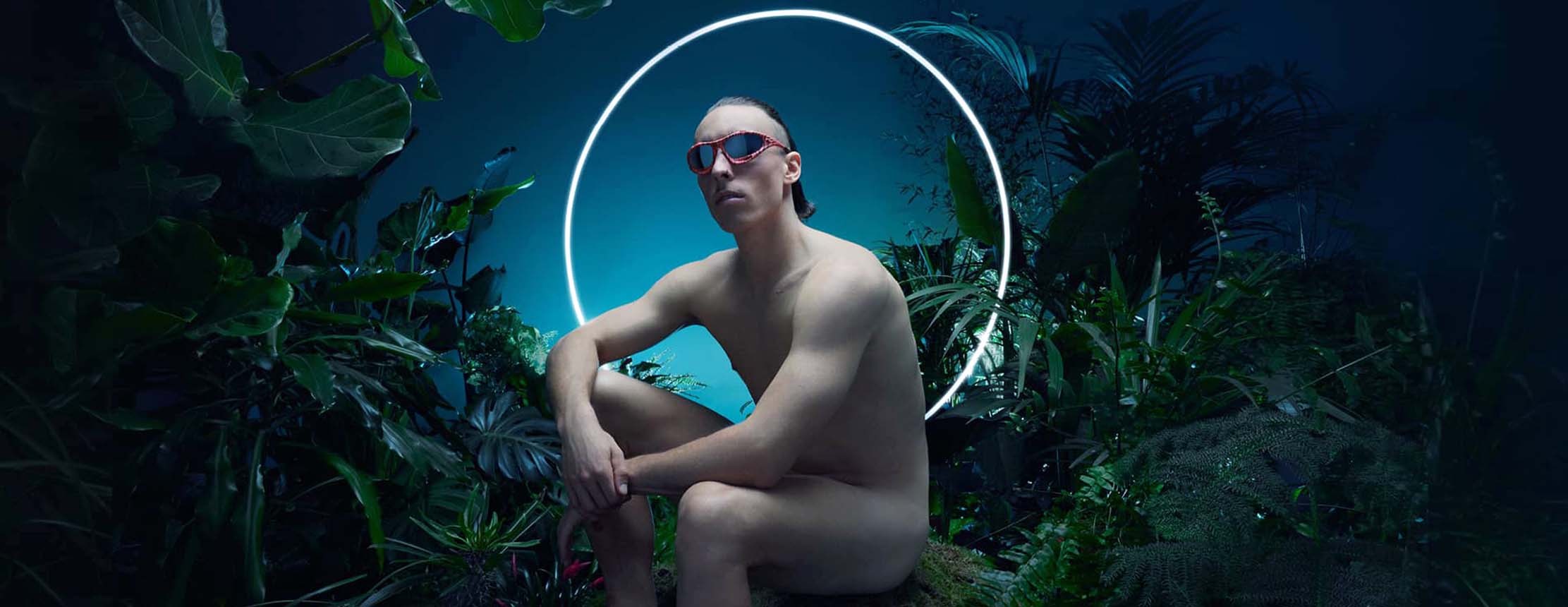 Naked man wearing oakley sunglasses