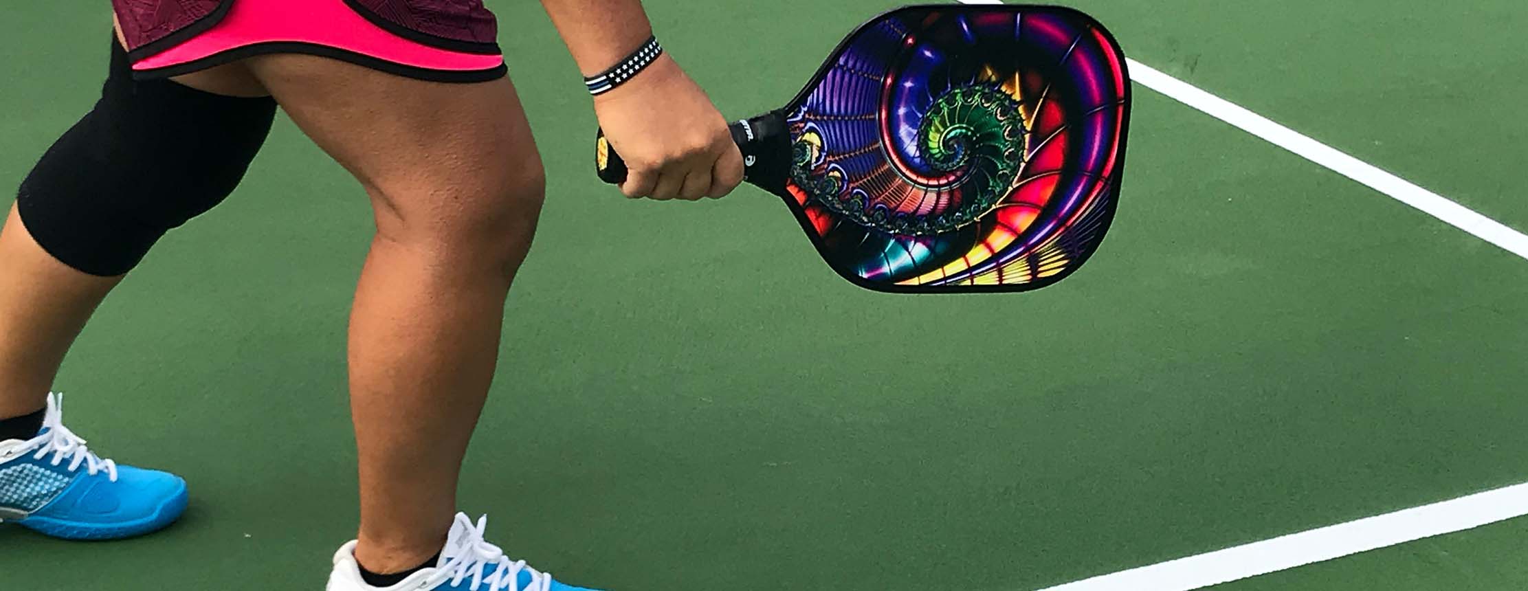 Pickleball player with colourful paddle