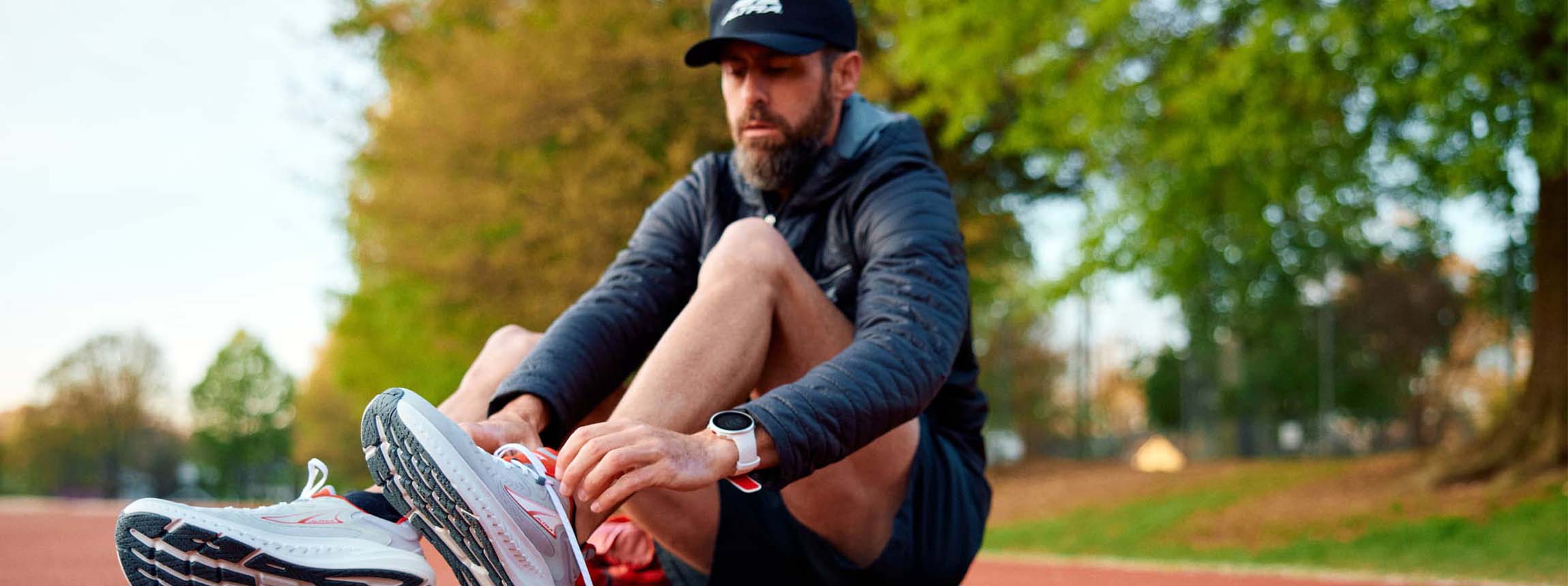 Runner sits to tie up altra running road laces