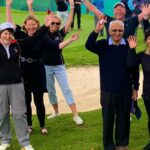 seniors on the golf course waving