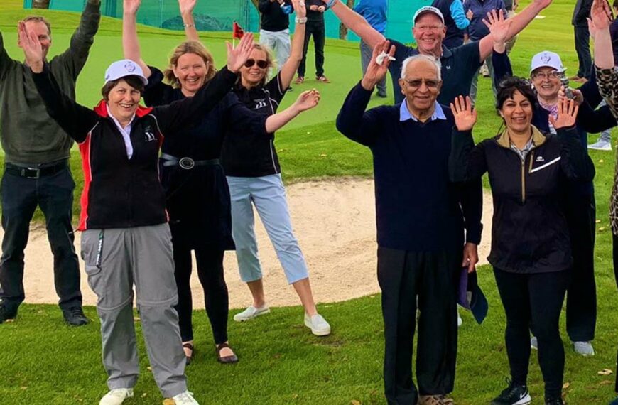 seniors on the golf course waving